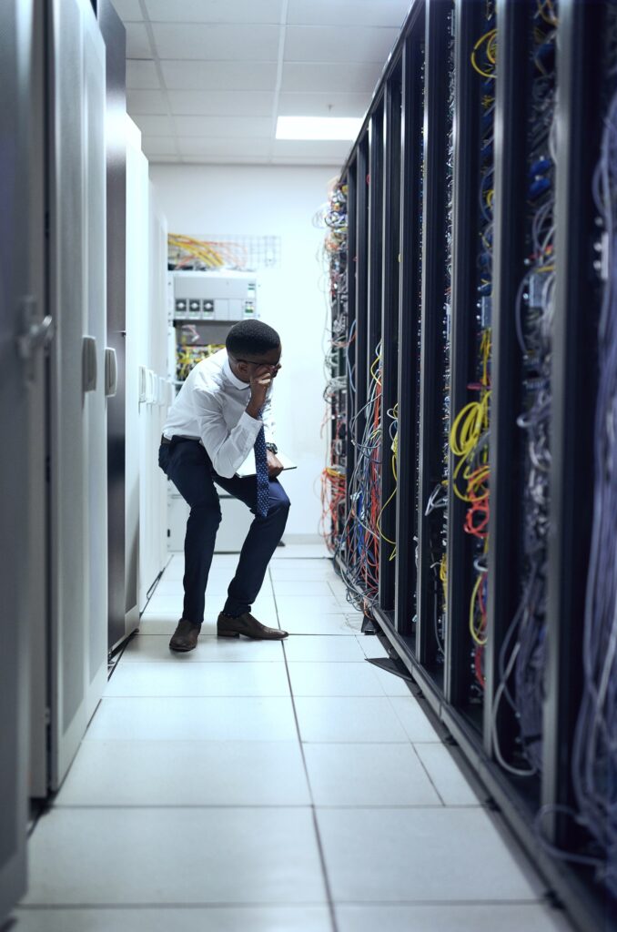Cropped shot of a IT technician working and checking if all the servers are up and running