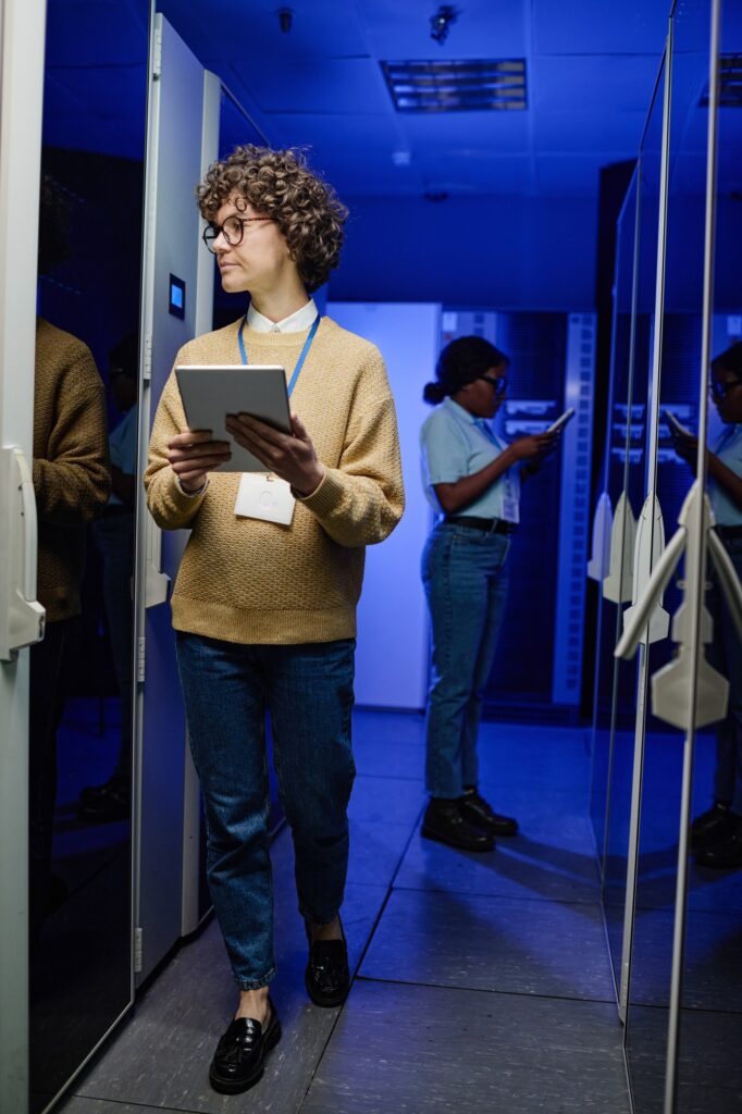 Technician analysing server in data center
